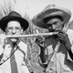 Associated Press Wide World photographer Ken Lucas tries his teeth on a piece of raw sugar cane with a Cuban sugar farmer, Jan. 25, 1946.
